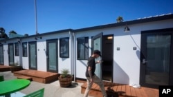 FILE: Steven Burcell walks to his room at the Five Keys' Mission Cabins transitional housing location in San Francisco, Aug. 26, 2024. 