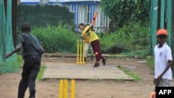 Boys play cricket in Freetown at Kingtom Oval, Sierra Leone's only cricket oval, November 15, 2012.