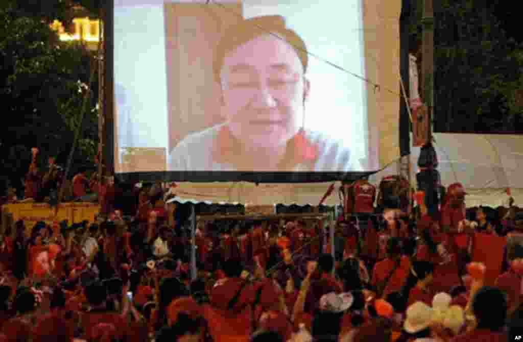 Supporters of deposed Thai premier Thaksin Shinawatra watch a video broadcast of him as they protest the government in Bangkok on March 14, 2010.