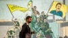 A man walks past a mural depicting supporters of the Syrian Democratic Forces, one of them raising a flag showing the face of Abdullah Ocalan — founding member of the militant Kurdistan Workers' Party, which is outlawed by Turkey, in Qamishli, Syria, on Dec. 16, 2024.