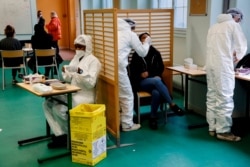 A student of the Emile Dubois high school takes part in a COVID-19 antigen test in Paris, France Nov. 23, 2020.