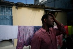 Entrepreneur and youth leader Pascéus Juvensky St. Fleur, 26, walks in the courtyard of his family's home in the Delmas neighborhood of Port-au-Prince, Haiti, Oct. 8, 2019.