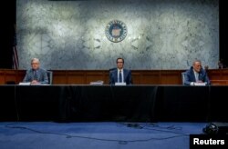 U.S. Senate Majority Leader Mitch McConnell, and U.S. Senate Minority Leader Chuck Schumer meet with Treasury Secretary Steve Mnuchin (C) to work on coronavirus economic aid legislation, on Capitol Hill, in Washington, March 20, 2020.