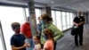 FILE - People wearing masks wait to board a flight in Kansas City, Mo., May 24, 2020. Governments and businesses are scrambling to change course following new federal guidance calling for the return of mask wearing in virus hot spots.