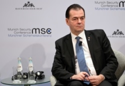 FILE - Romania's Prime Minister Ludovic Orban listens during a panel discussion at the annual Munich Security Conference in Germany, Feb. 16, 2020.
