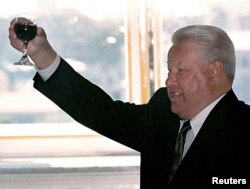 FILE - Russian President Boris Yeltsin makes a toast during a meeting with graduating cadets of Russian military schools June 28, 1999.