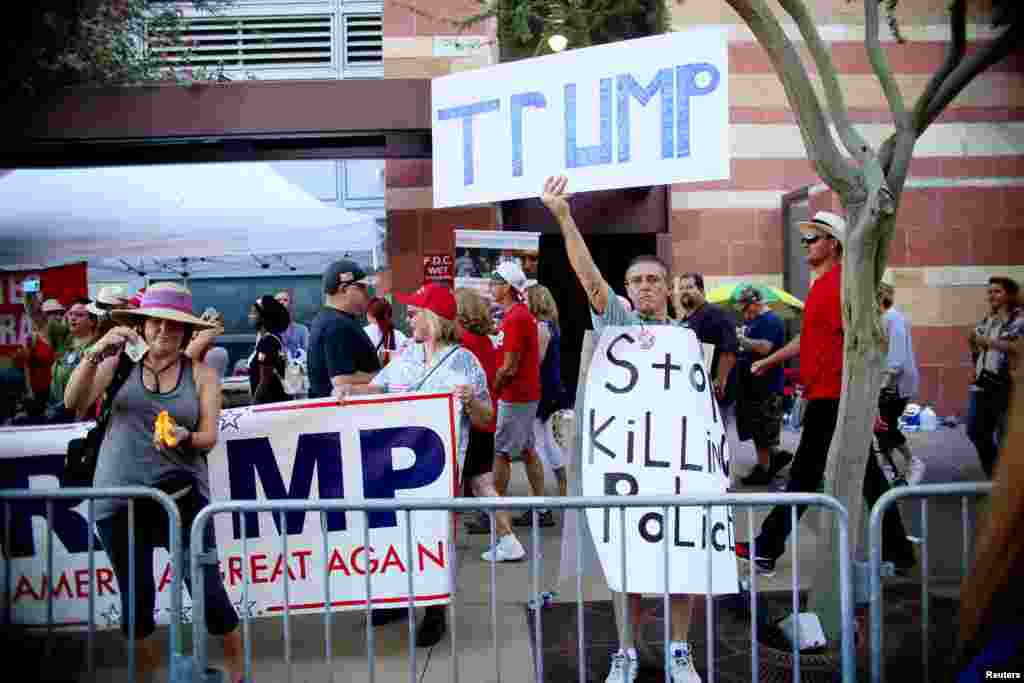 Pro Trump supporters face off with peace activists during protests outside a Donald Trump campaign rally in Phoenix, Ariz., Aug. 22, 2017.