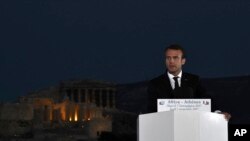 French President Emmanuel Macron delivers a speech at Pnyx hill as the ancient site of Acropolis is seen in the background in Athens, Thursday, Sept. 7, 2017. Standing at a Greek site where democracy was conceived, French President Emmanuel Macron called on members of the European Union to reboot the 60-year-old bloc with sweeping political reforms or risk a "slow disintegration. 