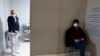 Seorang perawat berdiri di dalam bilik pusat vaksinasi COVID-19 "Promitheas Center", di Athena, Yunani, saat seorang pria menunggu untuk disuntik vaksin Moderna, Senin, 15 Februari 2021.