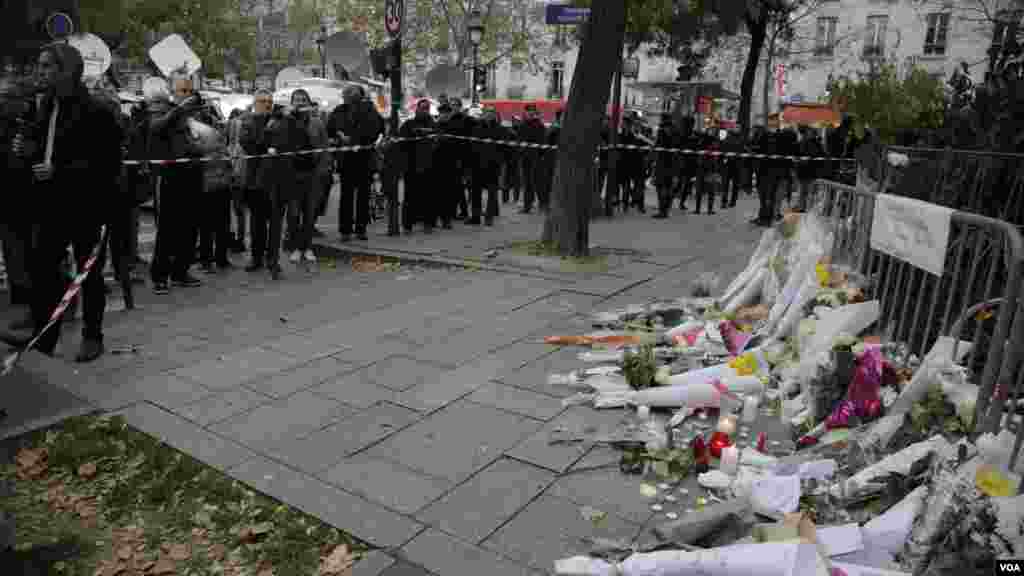 Mourners gather at a memorial outside the Bataclan Concert Hall a day after more than 120 people were killed in a series of attacks in Paris, Nov. 14, 2015.