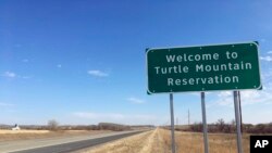 File - In this Wednesday, Oct. 24, 2018, file photo, a sign to the Turtle Mountain Reservation of Native Americans in North Dakota is shown before Election Day amid concerns over voter ID. 