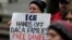 A protester holds a sign that reads "ICE Hands Off DACA Families Free Daniel," during a demonstration in front of the federal courthouse in Seattle, Feb. 17, 2017.