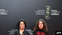 FILE — Palestinian actress and director Hiam Abbass and French-Algerian director Lina Soualem pose on the red carpet during the 20th Marrakesh International Film Festival in Marrakech on November 25, 2023.