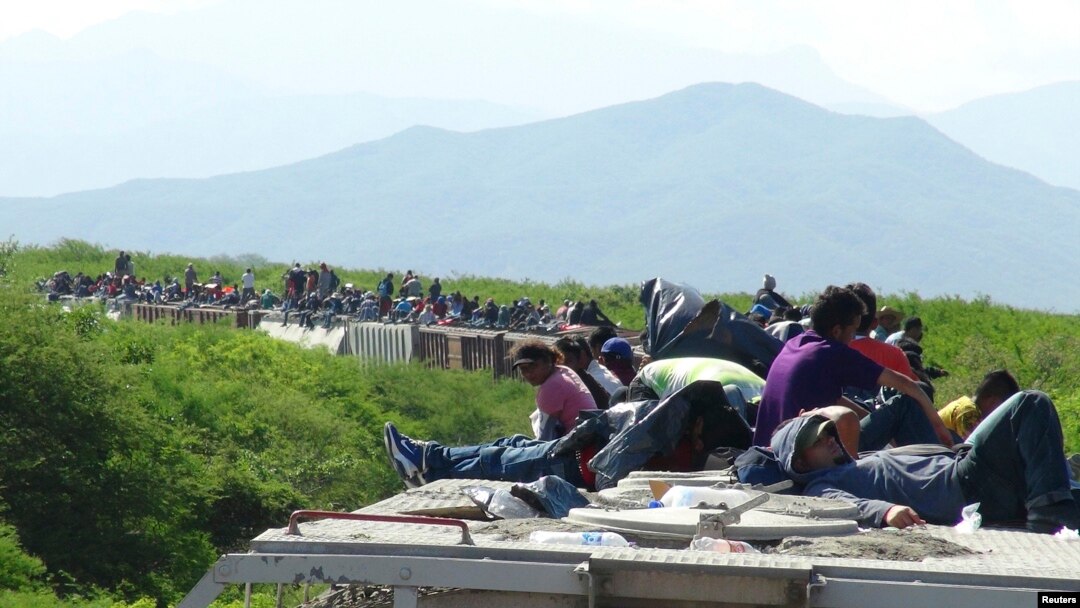 Orang-orang yang ingin masuk ke AS duduk di atas gerbong kereta barang, yang dikenal dengan La Bestia (The Beast) di Ixtepec, negara bagian Meksiko, Oaxaca, 18 Juni 2014. 