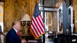 President Donald Trump speaks during a Christmas Eve video teleconference with members of the military at his Mar-a-Lago estate in Palm Beach, Fla., Dec. 24, 2019. 