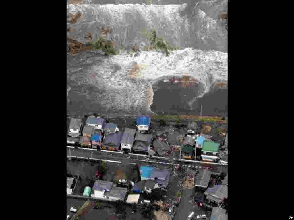 Houses are damaged by water following a tsunami and earthquake in Ibaraki city, Ibaraki Prefecture, March 11, 2011.