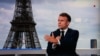 This photograph shows a television screen broadcasting France's President Emmanuel Macron on French TV channel France 2, on a set installed on the roof of the Musee de l'Homme (Museum of Mankind) at the Trocadero, with the Eiffel Tower seen in the background, on July 23, 2024.