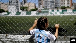FILE - Candelabra Villegas, 12-year-old, poses for a photo wearing Lionel Messi's national team jersey, in Buenos Aires, Argentina, Jan. 31, 2019.