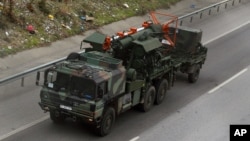 FILE - German military trucks carrying NATO's Patriot Missile Defense leave the port in the Mediterranean city of Iskenderun, Turkey, Jan. 22, 2013.