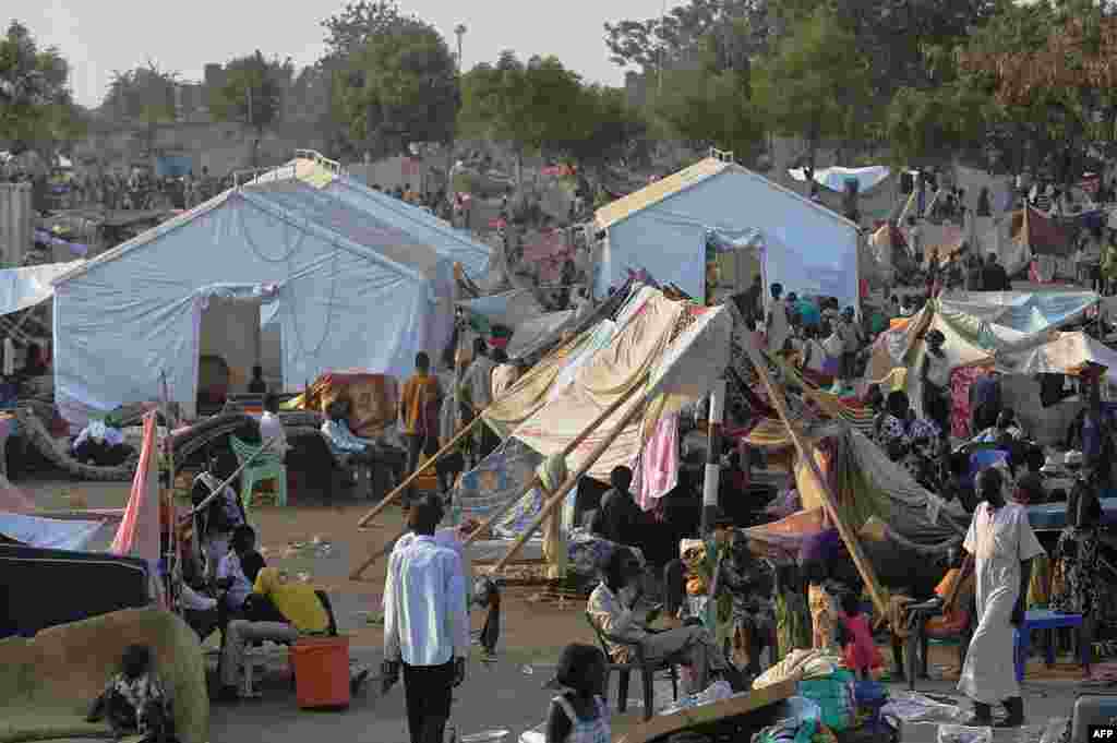 People gather at a makeshift camp at the United Nations Mission in South Sudan (UNMISS) compound in Juba, Dec. 22, 2013, a week after South Sudan erupted in violence.