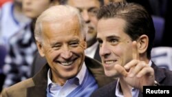 FILE PHOTO: U.S. Vice President Joe Biden and his son Hunter Biden attend an NCAA basketball game between Georgetown University and Duke University in Washington, U.S., January 30, 2010. REUTERS/Jonathan Ernst -/File Photo