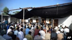 Afghan refugees offer Eid al-Adha prayers at a mosque in the Kazana Refugee camp on the outskirts of Peshawar, Pakistan, July 20, 2021. 