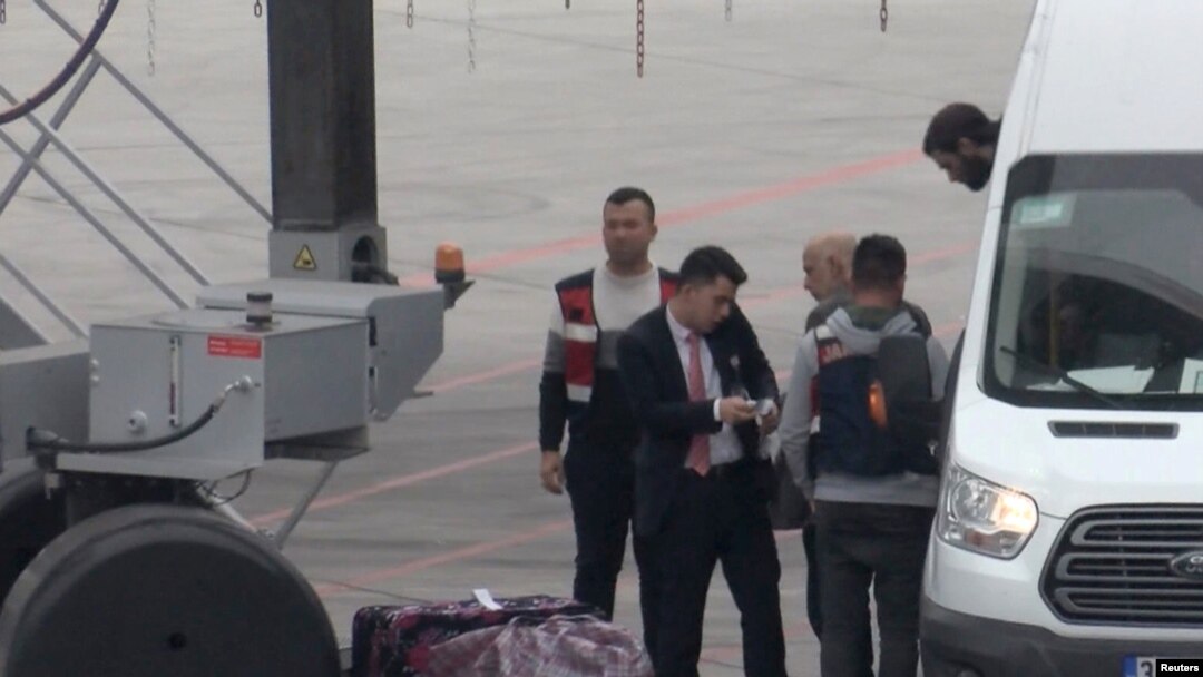 A still image taken from a video shows German Islamic State detainees, being deported back to Germany, boarding a plane at Istanbul International Airport, Nov. 14, 2019.