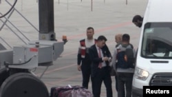A still image taken from a video shows German Islamic State detainees, being deported back to Germany, boarding a plane at Istanbul International Airport, Nov. 14, 2019.