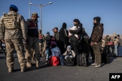 Syrian refugees who live in Turkey wait in a line at Cilvegozu crossborder gate before entering Syria at Reyhanli district in Hatay, Turkey, on Dec. 9, 2024.