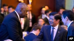 U.S. Secretary of Defense Lloyd Austin greets Philippine President Ferdinand Marcos Jr., center, and Singapore Prime Minister Lawrence Wong, right, at the Shangri-La Dialogue summit in Singapore on May 31, 2024. 