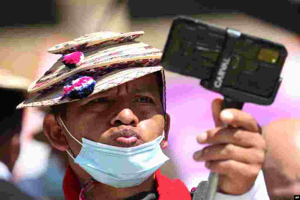 A Misak Indigenous man stikes a pose while taking a selfie during an anti-government protest over proposed tax increases on public services, fuel, wages and pensions, in Bogota, Colombia, June 2, 2021.