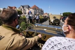 World War II history enthusiasts parade in WWII vehicles in Ouistreham, Normandy, June 5, 2021, on the eve of 77th anniversary of the assault that helped end the war.