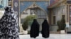 Head-to-toe veiled Iranian women walk at the shrine of Saint Saleh in northern Tehran, April 6, 2021.