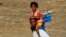 FILE - Residents fleeing an attack on the South Sudanese town of Rank arrive at a border gate in Joda, along the Sudanese border.