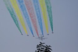 Planes from the Chinese People's Liberation Army (PLA) air force fly during a rehearsal of the military parade on October 1 to mark the 70th anniversary of the founding of the People's Republic of China, in Beijing.