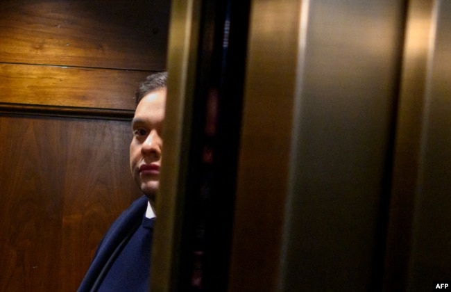 Rep. George Santos, R-NY, takes an elevator while on his way from his office to the US Capitol in Washington, DC, on December 1, 2023. The House voted to expel him later in the day. (Photo by Mandel NGAN / AFP)