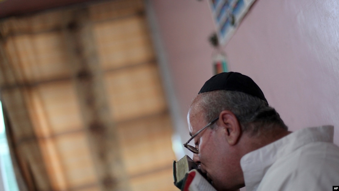 FILE - In this Aug. 29, 2009, photo, Zebulon Simentov, the last known Jew living in Afghanistan and the caretaker and sole member of Afghanistan's only working synagogue, kisses his prayer book while observing Shabbat in his Kabul home. 