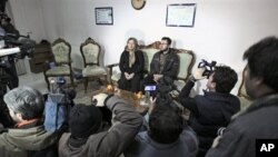 Iranian Sakineh Mohammadi Ashtiani, left, who has been sentenced to death by stoning for adultery, attends a news briefing as she meets with her son, Sajjad, in the northwestern city of Tabriz, Iran, 01 Jan 2011.