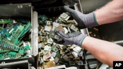 A worker handles components of electronic elements at the Out Of Use company warehouse in Beringen, Belgium, July 13, 2018.