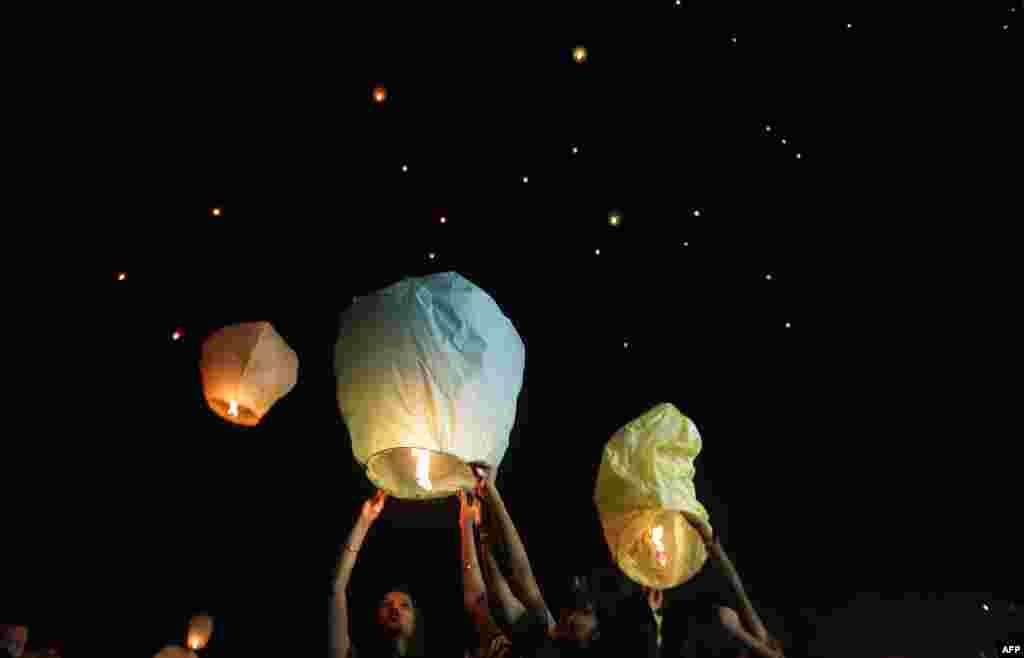 Indian volunteers of a social organization release lanterns in Kolkata to promote a peaceful and eco-friendly Diwali and create awareness against child labor in the fire cracker industry.