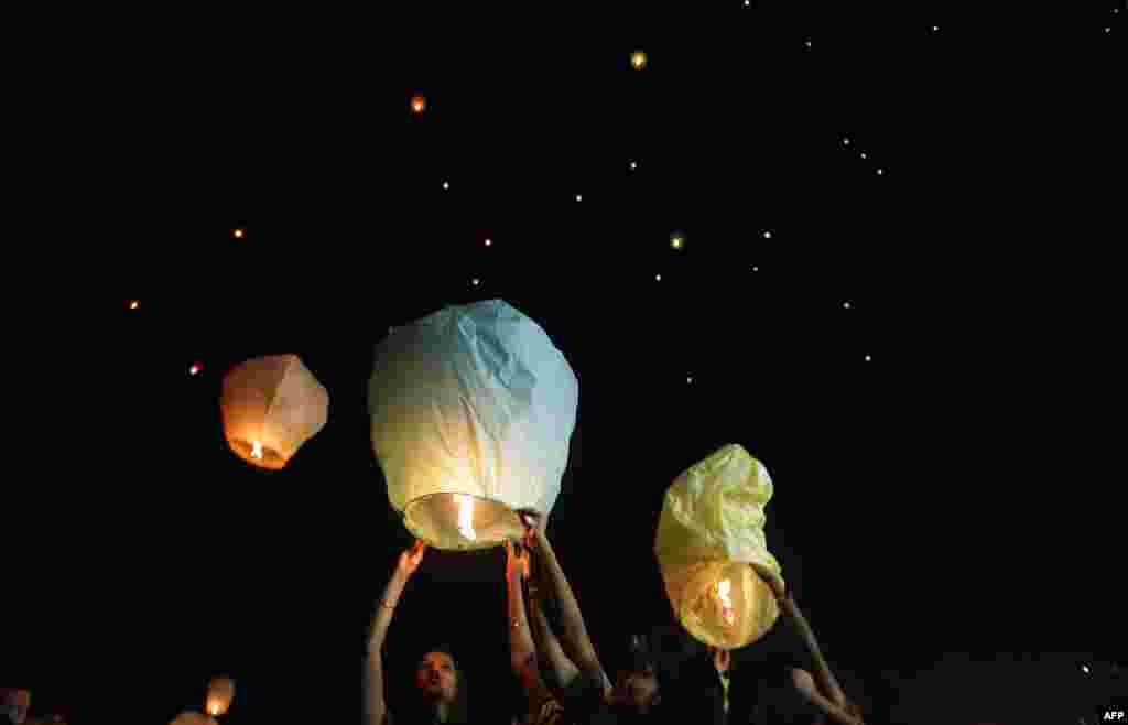 Indian volunteers of a social organization release lanterns in Kolkata to promote a peaceful and eco-friendly Diwali and create awareness against child labor in the fire cracker industry.