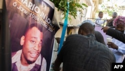 FILE - Family react during a funeral ceremony for Mario Jn Louis, a police officer killed by armed gangs in Port-au-Prince, Haiti, on Dec. 19, 2024.