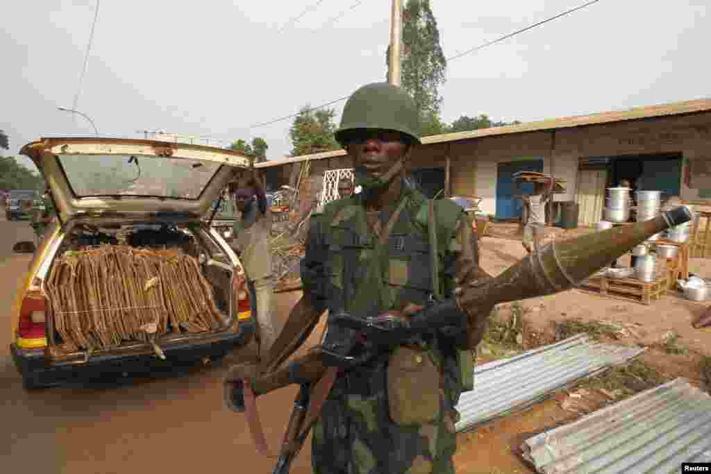 A DRC soldier, part of an African peacekeeping force, patrols along a street in Bangui, Feb. 12, 2014. 