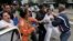 Cuban security personnel detain members of the Ladies in White group during a protest on International Human Rights Day, in Havana, Dec. 10, 2014.