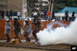 FILE - Riot police fire tear gas grenades at demonstrators during protests in the capital Nairobi, Kenya on July 7, 2023.