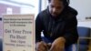 Oddelio Reid fills out paperwork before getting an influenza vaccine injection during a flu shot clinic at Dorchester House, a health care clinic, in Boston, Massachusetts January 12, 2013.