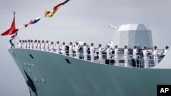 FILE - China's frigate Huangshan is seen anchored in the waters off RSS Singapura Changi Naval Base, May 15, 2017, in Singapore. China and members of the Association of Southeast Asian Nations will engage in naval exercises next year.