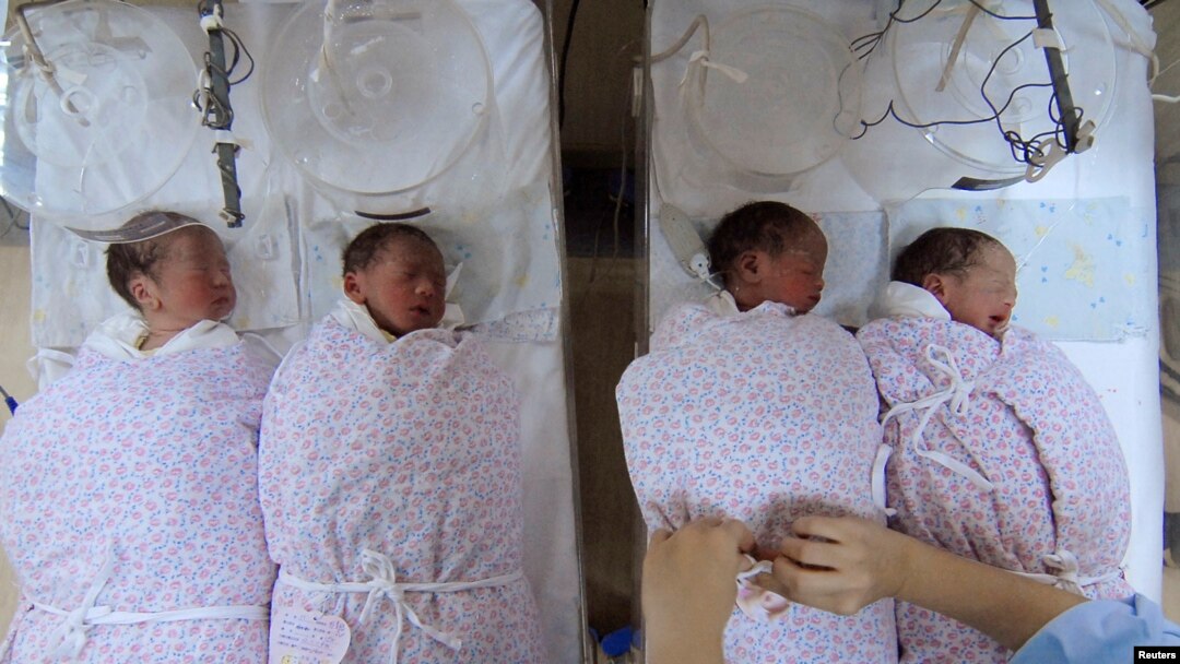 A nurse takes care of quadruplets at a hospital in Shanghai January 11, 2007. China's population will increase by 200 million in 30 years, according to a report published on Thursday, Xinhua News Agency reported. CHINA OUT REUTERS/China Daily (CHINA) - RT