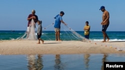 FILE - Palestinian fishermen work, amid the ongoing conflict between Israel and Palestinian Islamist group Hamas, in Khan Younis, in the southern Gaza Strip, Oct. 31, 2024. 