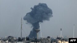 2023年12月1日，以色列和哈马斯恢复战斗后，以色列对加沙地带南部拉法发动袭击，浓烟从建筑物上空升起。(法新社）